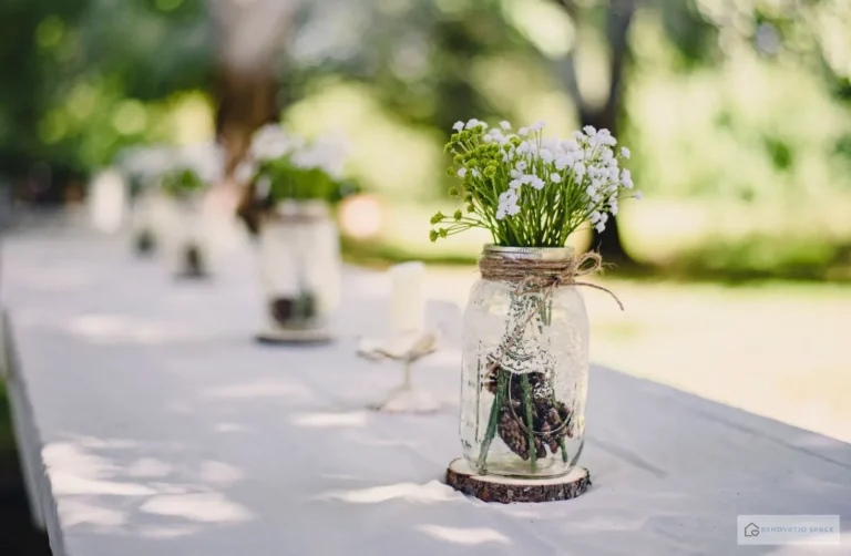 Mason jar filled with water and fresh herb stems as a kitchen table centerpiece