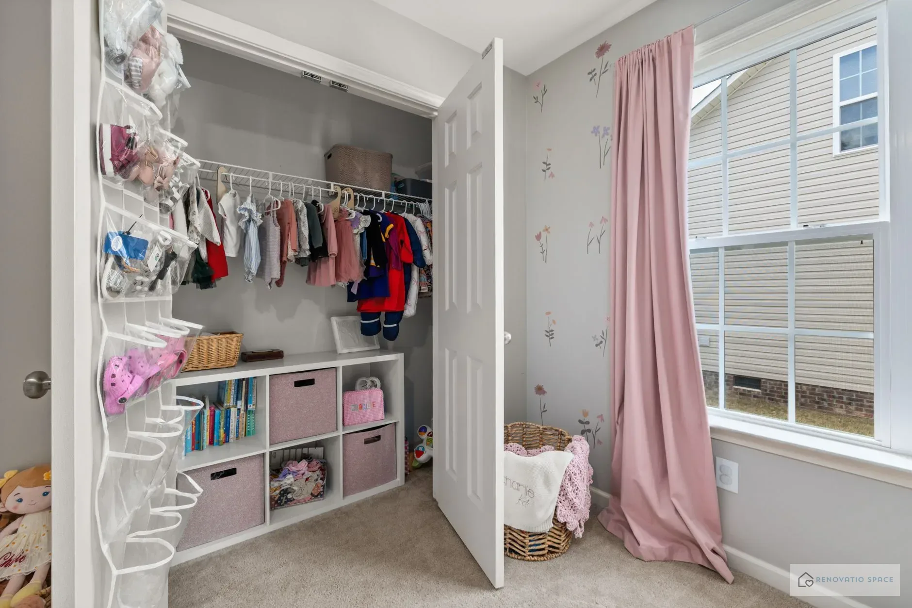 Under-bed storage drawers with toys and books in a shared children's bedroom