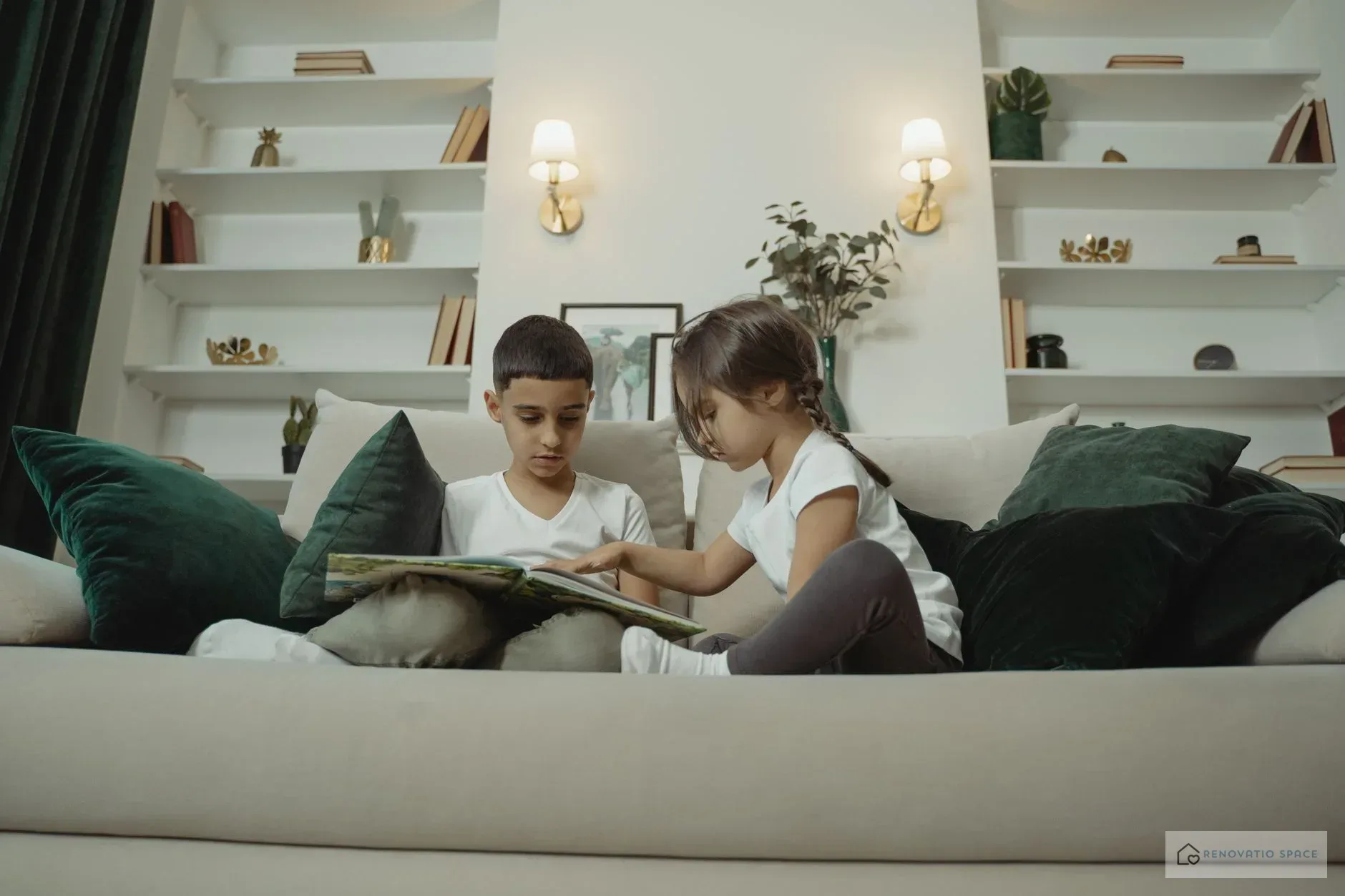 A shared children's room with neutral walls, two beds, and personal decorations for a boy and a girl